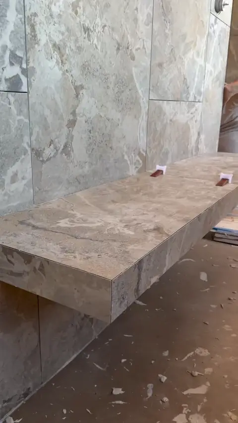 DreamDim crew setting a marble shower bench