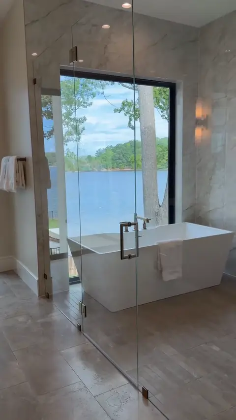 Primary bath with freestanding tub and frameless glass shower